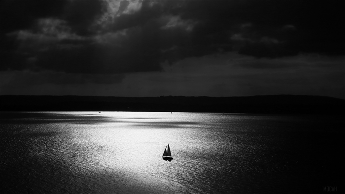 Sailboat on a dark, stormy sea at night