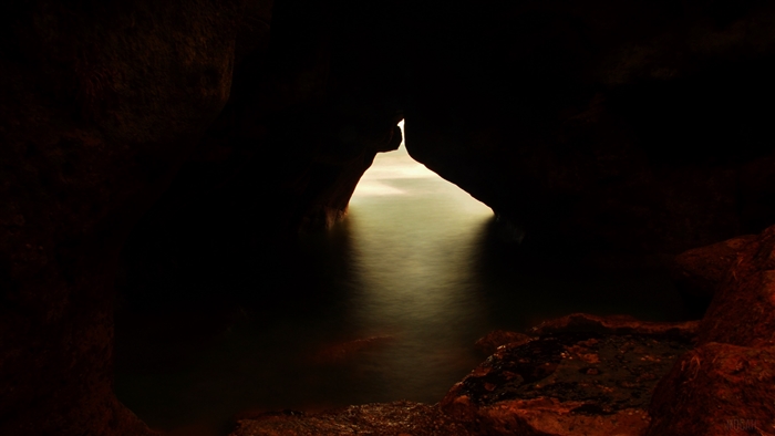 Cave entrance with water and light