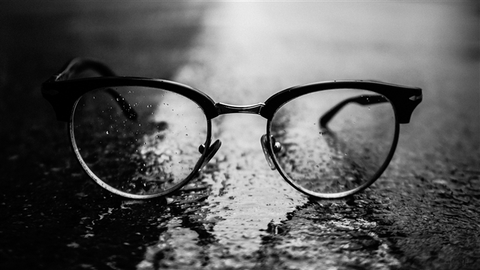 Close-up of black glasses with water droplets