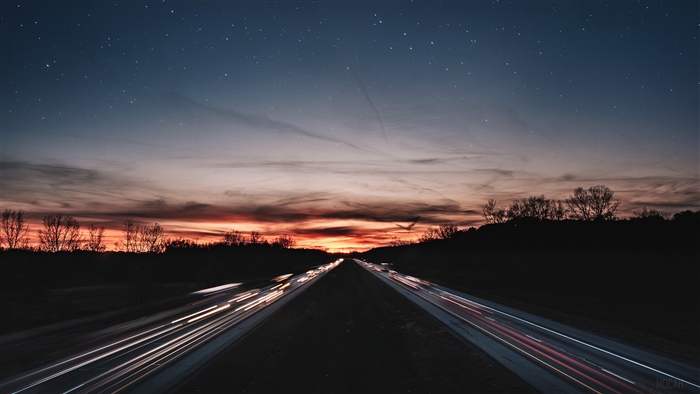 Highway at Dusk with Starry Sky and Light Trails