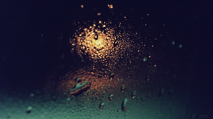 Raindrops on glass with light at night 4K