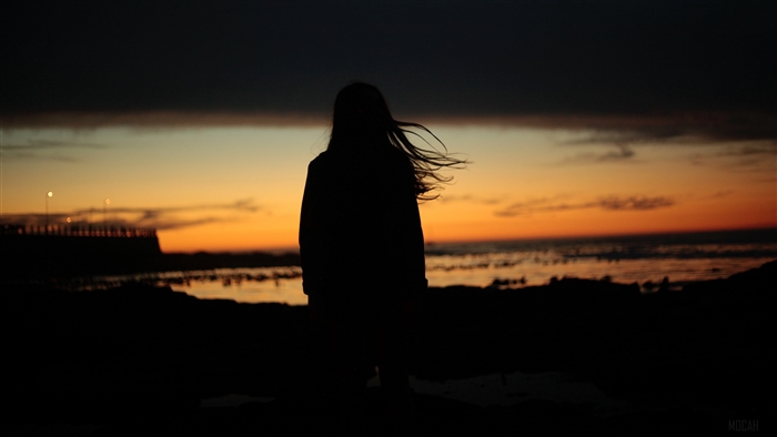 Girl silhouette at sunset by the sea 4K