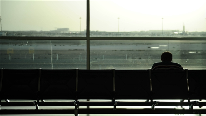 Person waiting at airport gate 4K