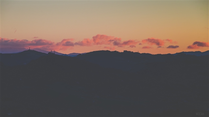 Sunset over mountains with pink clouds