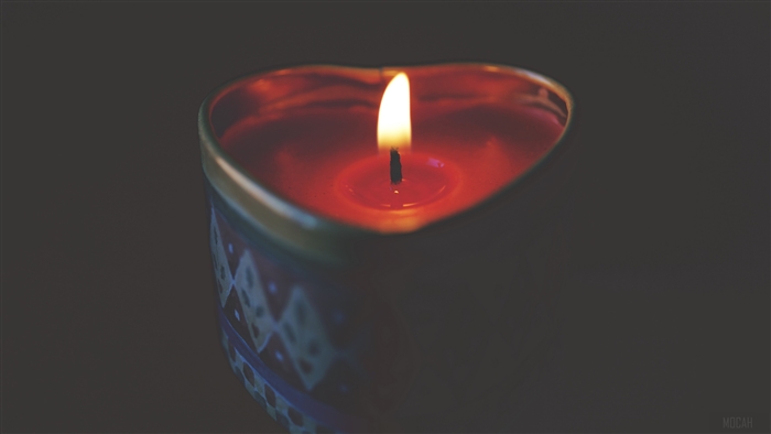 Heart-shaped red candle with flame 4K