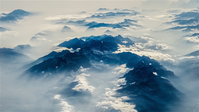 Aerial view of misty mountains in the Alps 4K