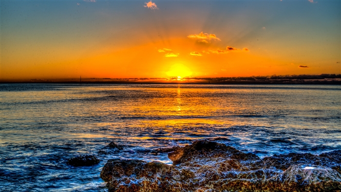 Sunset over the ocean with rocks