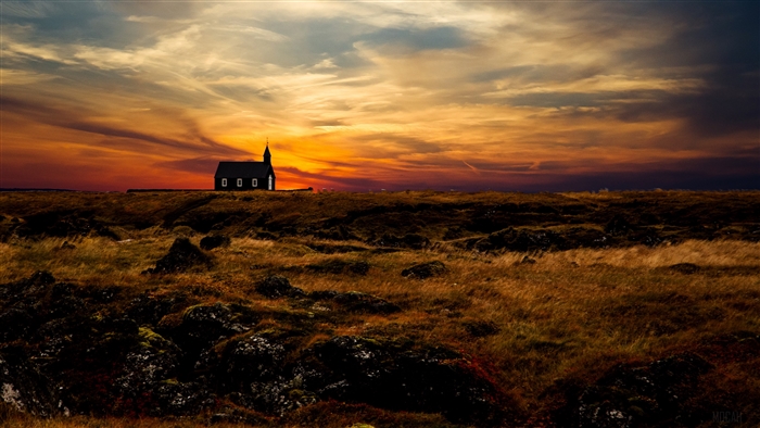Black church on a hill at sunset in Iceland 4K