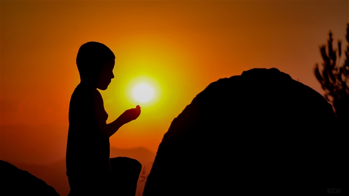 Child praying at sunset silhouette 4K