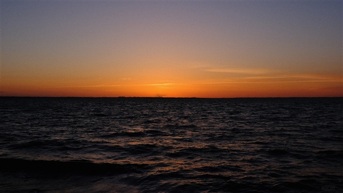 Sunset over the dark sea horizon 4K