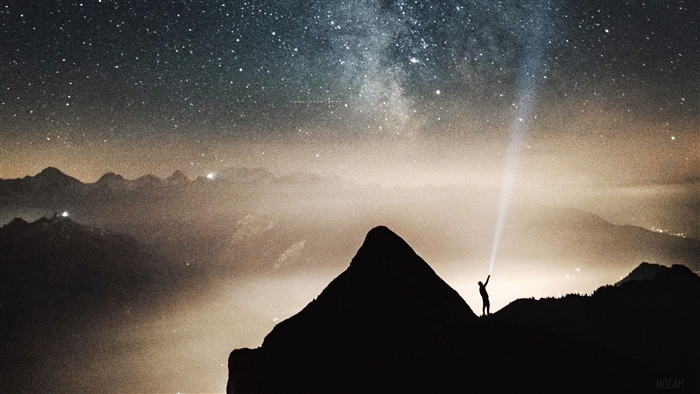 Silhouette with flashlight under starry sky and mountains 4K