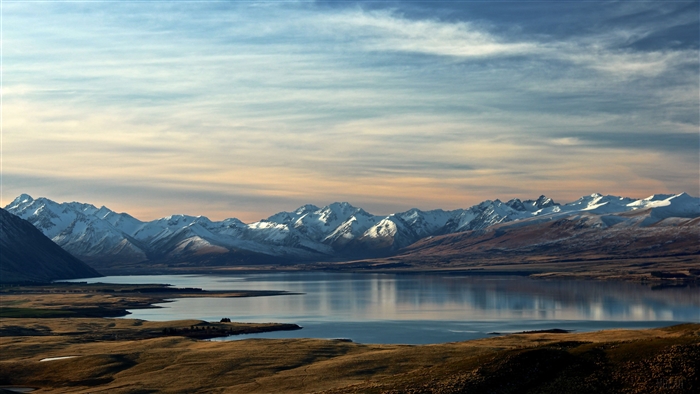 Snowcapped Mountain Range with Calm Lake