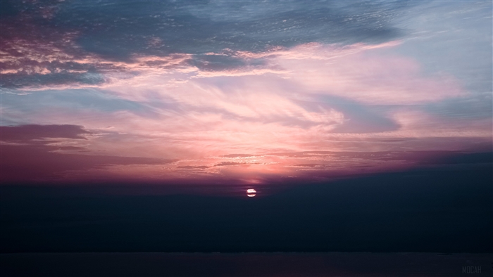 Sunset over the sea under clouds