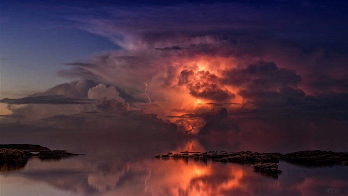 Thunderstorm over the ocean with lightning