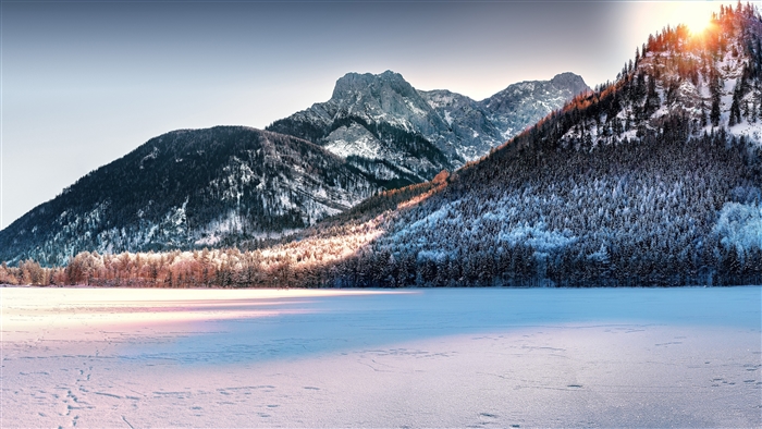 Snow Covered Mountains and Frozen Lake at Sunset