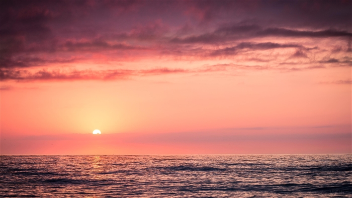 Sunset over the ocean with clouds