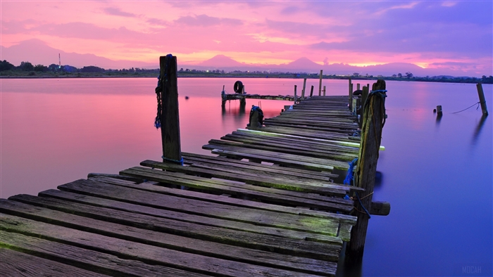 Wooden Dock on Calm Water During Sunset