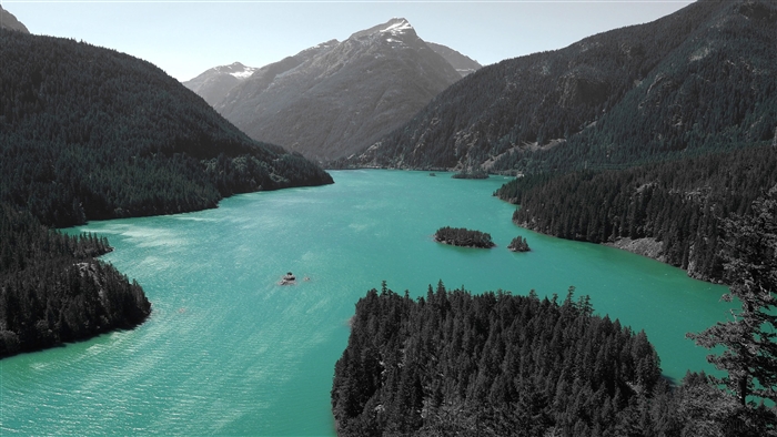 Turquoise Lake Surrounded by Dark Forested Mountains 4K