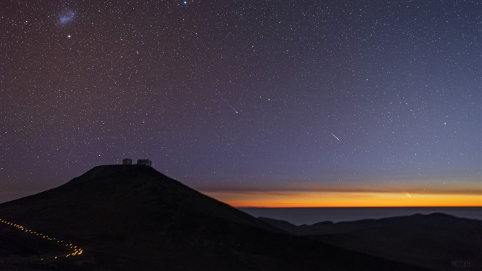 Observatory on a hill under starry sky at sunset