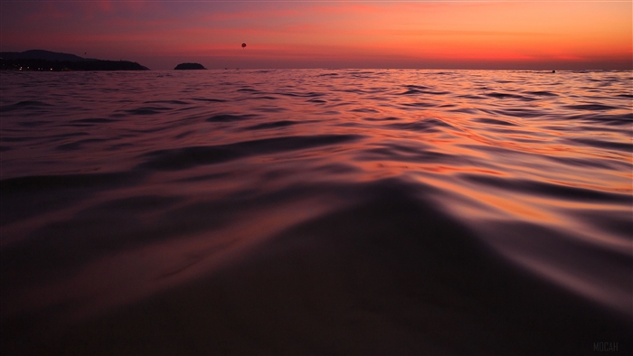Sunset over the ocean with a hot air balloon