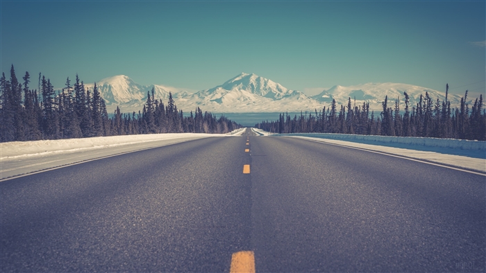 Open Road Leading to Snow-Capped Mountains