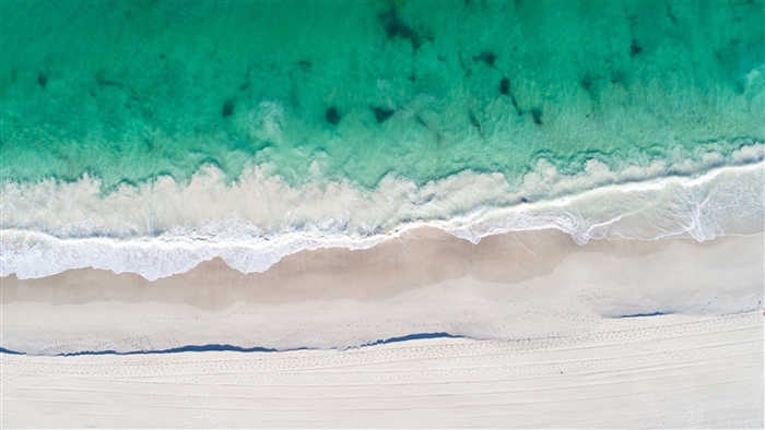 Aerial View of Beach with Clear Ocean and Sand 4K