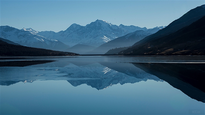 Snowy Mountain Peaks Reflected in a Calm Lake