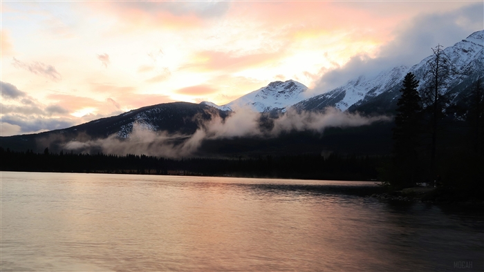 Lake and Snowy Mountains at Dusk with Fog