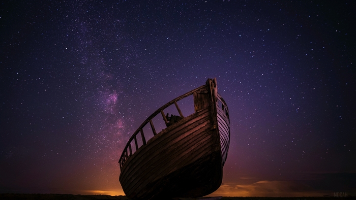 Abandoned boat under starry night sky 4K