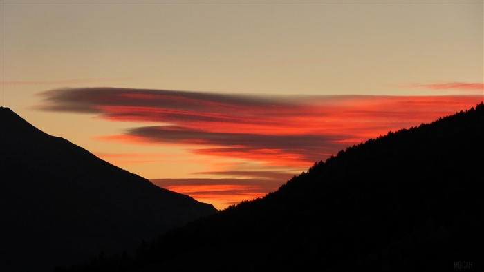 Sunrise over mountains with red clouds
