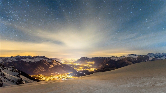 Snowy Mountains Over City Lights Under Stars 4K