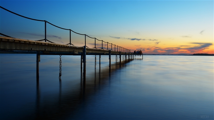Pier over water at sunset 4K
