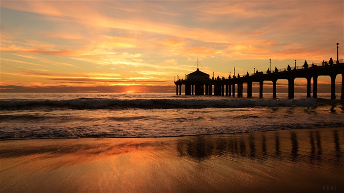 Sunset over the ocean with a pier