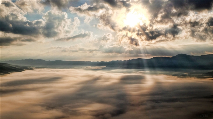 Sun Rays Through Clouds Over Mountains 4K