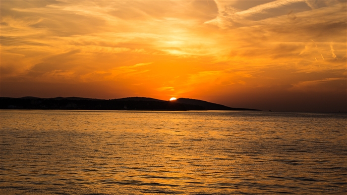 Sunset over the sea with island mountains 4K