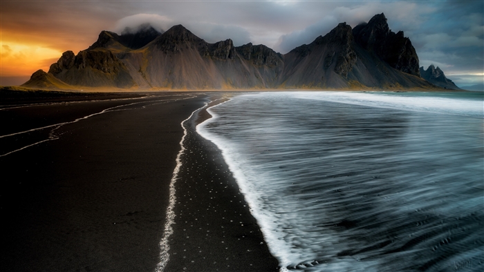 Black Sand Beach with Jagged Mountains in Iceland 4K