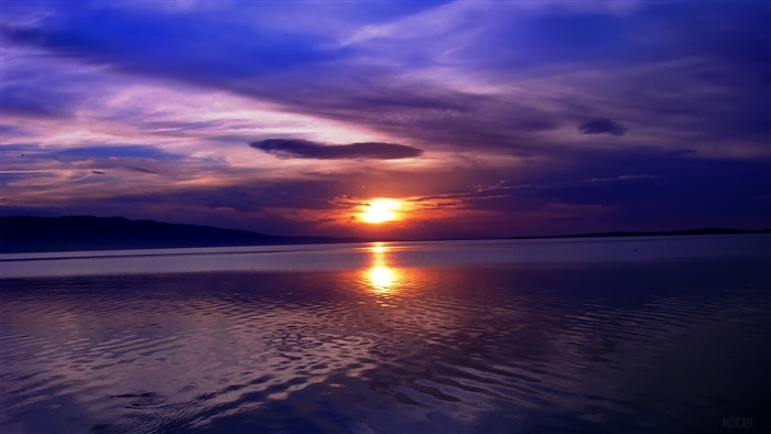 Sunset over a lake with mountains