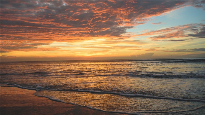 Sunset over the ocean with colorful clouds