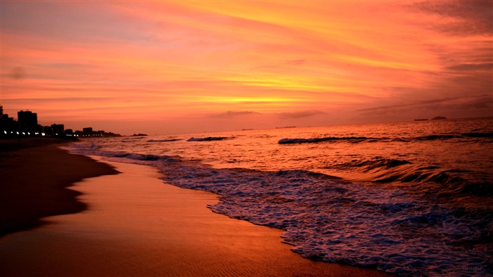 Beach Sunset with City Skyline and Ocean Waves 4K