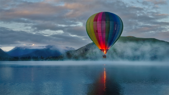 Hot Air Balloon Over Misty Lake at Sunrise 4K