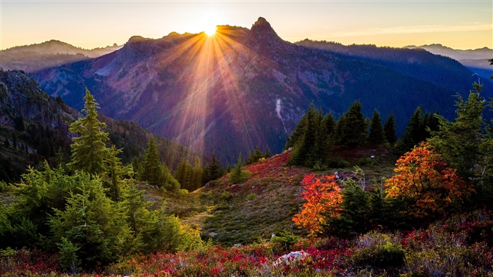 Sunrise over mountains with sun rays