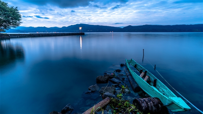 Boat near island at dusk 4K