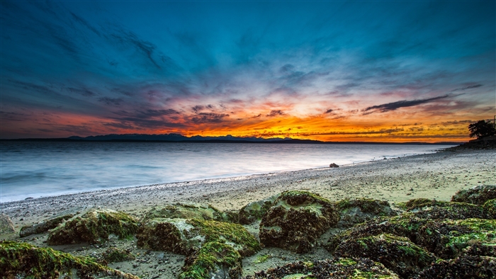 Beach Sunset Over Water with Mountains