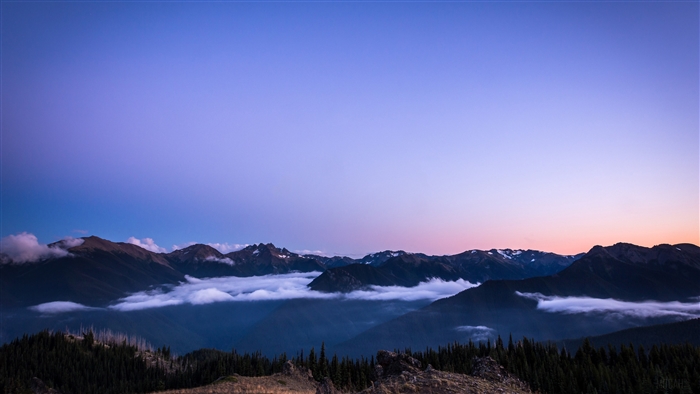 Sunset over mountains with clouds