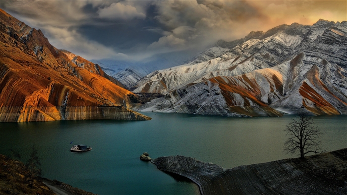 Lake and snow-capped mountains with a boat