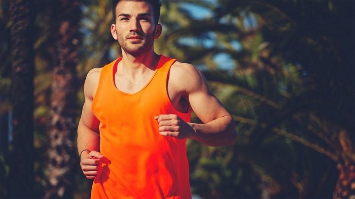 Man running in an orange tank top