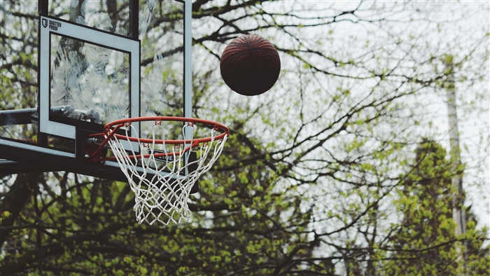 Basketball hoop with ball in the air