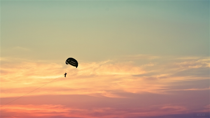 Parasailing in the sky at sunset 4K