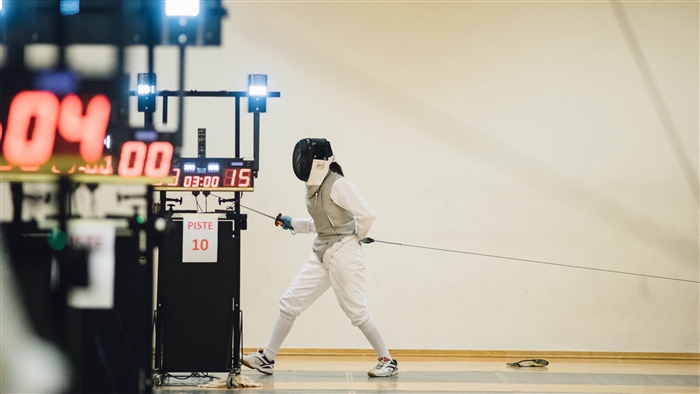 Fencing match with scoreboard and piste 10