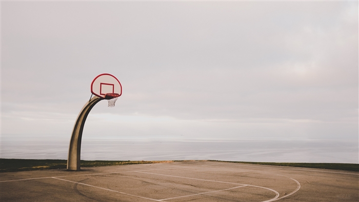 Basketball hoop on court by the ocean
